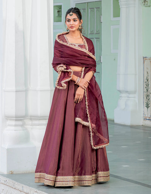 WINE MAGENTA HAND EMBROIDERED LEHENGA SET WITH SELF AND SILVER EMBROIDERY  PAIRED WITH A MATCHING DUPATTA AND CUT WORK NECKLINE. - Seasons India