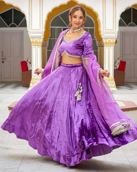 Paris De Boutique - An exquisite ensemble to enchant your perfect occasion.  Our stunning grape shaded lehenga with a intricately hand-embroidered crop  top adorned with crystals and gems. The floral bunches on
